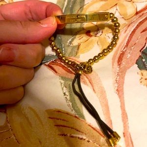 Michael Kors gold beaded with adjustable leather straps with the logo on front